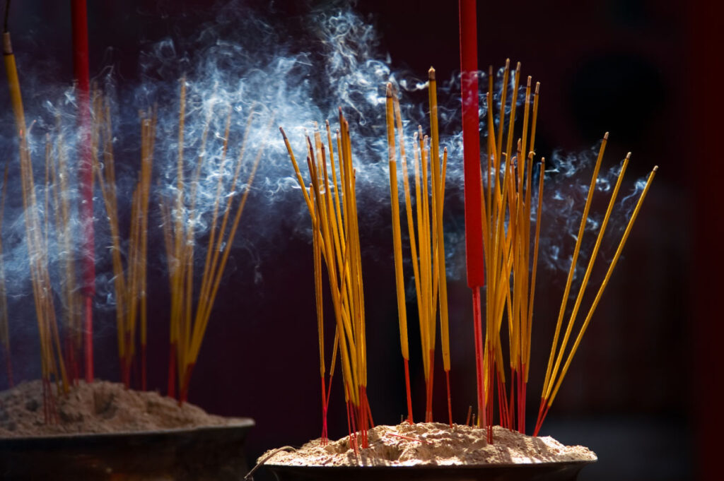 incense sticks burning and smoke curling